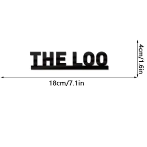 Detail view of black acrylic THE LOO wall sticker sign with dimensions 18x4cm for decor.