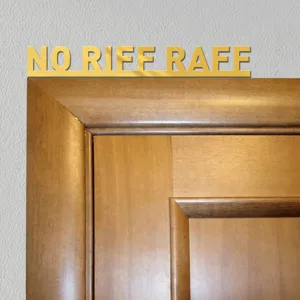Gold acrylic wall sticker detail showing the elegant typography mounted above wooden frame.