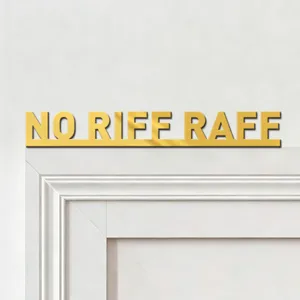 Gold mirror acrylic wall sticker detail, elegant text display closeup on clean white wall.