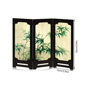 Detailed view of the mini wooden folding screen showing delicate bamboo art and black frame texture.