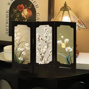 Detail shot of vintage Chinese style folding screen desk ornament with floral design, elegant decor.