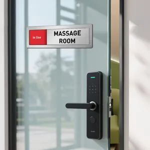Detail view of sliding room status sign with massage room text, sleek metal office sign