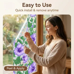 Close-up detail showing the static cling window film with purple flower pattern being applied.