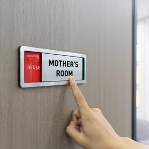 Close up detail view of sliding door status sign with clear text and modern metal frame design.