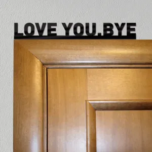 Black acrylic wall sticker with love you bye quote for modern home door frame decor.