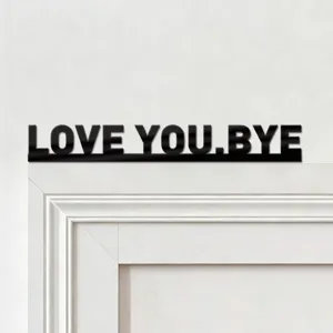 Close up detail of black acrylic letter wall sticker featuring love you bye text for modern home.