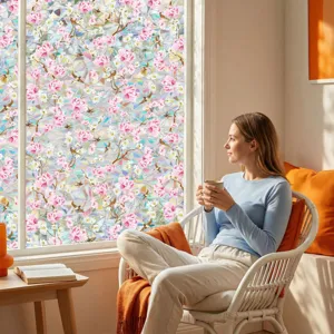 Detail view of decorative floral window film showing a cozy living room scene with natural sunlight.