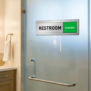 Sliding door restroom status sign, metal brushed indicator for office bathroom privacy.