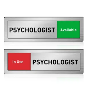 Sliding door status sign detail showing psychologist office availability indicator with metal brushed finish.