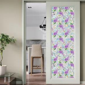 Detail shot of decorative floral window glass film with purple lilac pattern for privacy.