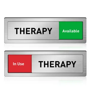 Detailed view of sliding therapy room door status sign featuring metal brushed finish.