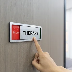 Close up view of the sliding door sign showing metal frame and therapy room text indicator.