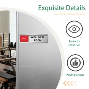 Sliding room status sign detail showing metal brushed finish and clear indicator text.