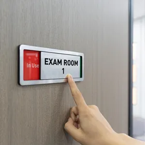 Detailed close-up shot of the sliding door status sign mounted on wooden door, functional.