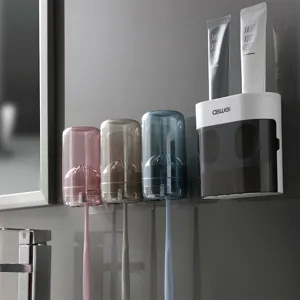Soportes de cepillos de dientes de pared con dispensador automático de pasta de dientes y vasos.