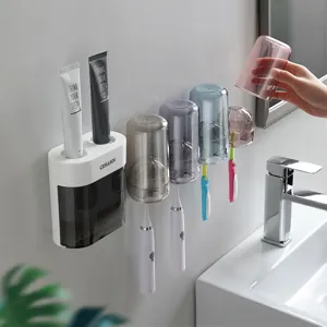 Soportes de cepillos de dientes de pared con dispensador automático de pasta dental.