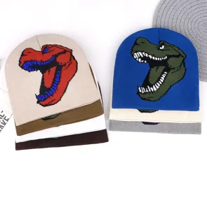 Close-up detail of winter knit beanies featuring colorful cartoon dinosaur head patterns.