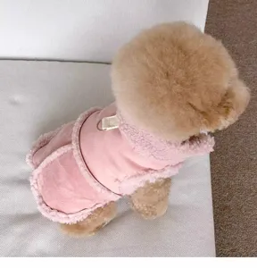 Close-up detail of the warm pink pet vest, showing soft fleece lining and metal leash ring.