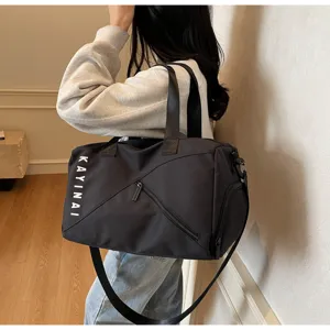 Detailed view of the black travel gym bag with shoulder strap, stylish and functional.