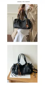 Vista dettagliata della borsa tote nera in pelle morbida con coulisse elegante.