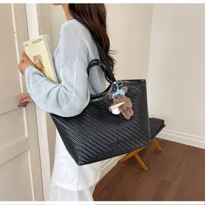 Stylish black woven tote bag for women, large capacity casual commuting single shoulder bag.