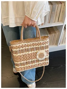 Woven straw handbag for women, casual tote bag with flower decor, stylish shoulder bag.