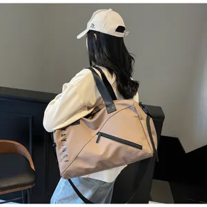 Detail view of khaki travel duffel bag with black straps and side print for gym and sports