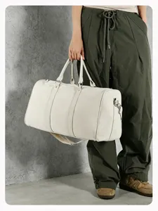 Detail view of large canvas travel duffel bag with handles for gym, short trips, and daily use.