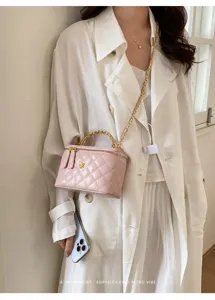 Pink quilted chain vanity bag for women, stylish shoulder handbag with elegant top handle.