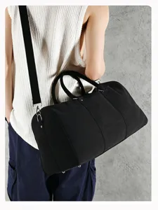 Large capacity black canvas travel duffel bag, casual boston handbag with shoulder strap.