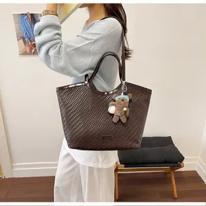 Woven tote shoulder bag for women, large capacity commuter handbag with cute bear pendant.