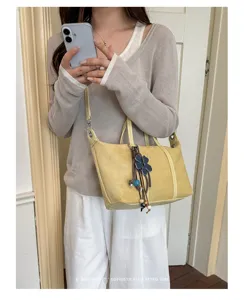 Suede dumpling shoulder bag detail, minimal retro style daily commuter crossbody accessory.