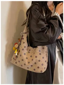 Detailed view of casual suede polka dot shoulder bag, soft texture and large capacity daily use.