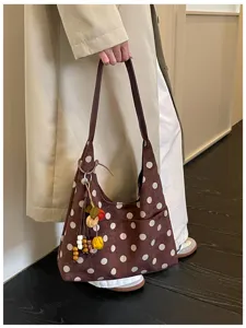 Retro brown suede polka dot hobo shoulder bag detail, stylish autumn daily casual commuter tote.