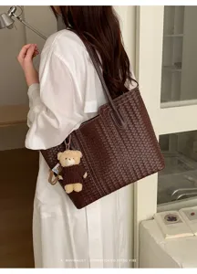 Stylish brown woven leather tote bag for women, large capacity shoulder handbag with bear charm.