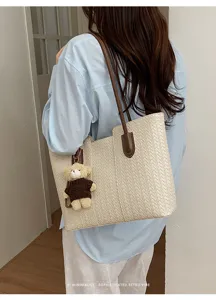 Chic woven tote bag with cute bear charm, perfect for daily commute and stylish office wear.
