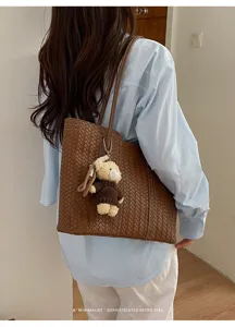 Woven leather tote bag for women, stylish large capacity shoulder bag with cute bear charm.