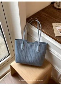 Minimalist woven tote bag for women, stylish large capacity shoulder bag in light blue.