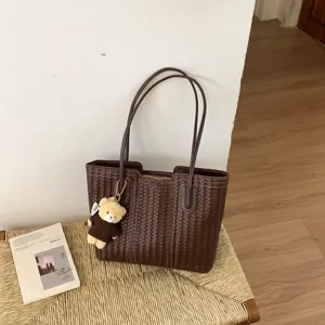 Brown woven tote bag for women, stylish large capacity shoulder handbag with cute bear pendant.