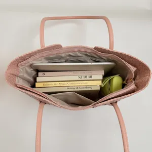 Chic pink woven tote bag with large capacity, perfect for daily commuting and office work.