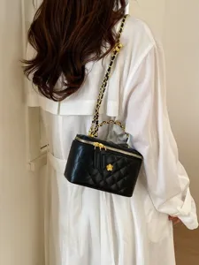 Elegant black quilted chain shoulder bag for women, chic crossbody vanity box handbag with gold flower.