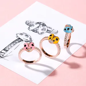 Primer plano detallado de anillos de mariquita coloridos con diamantes de imitación.