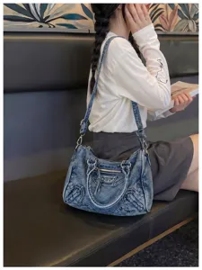 Vintage washed denim motorcycle shoulder bag for women, trendy chic hobo crossbody handbag.