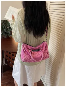 Vintage washed pink denim motorcycle shoulder bag lifestyle detail view with chic style.