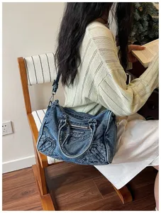Vintage washed denim motorcycle shoulder bag for women, chic retro crossbody handbag.