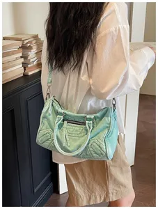 Vintage washed denim motorcycle shoulder bag for women, retro chic design with stylish zips.