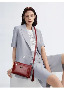 Red PU leather crossbody shoulder bag detail view showing multi-layer design and hardware.