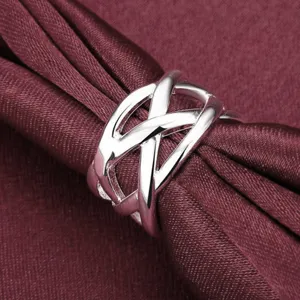 Detailed shot of a silver plated woven ring and silk scarf buckle with hollow geometric design.