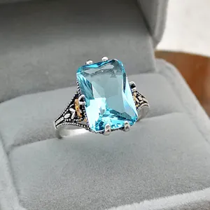 Vintage 925 Thai silver light blue topaz ring with exquisite gold-plated floral carved band.