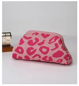 Pink leopard print knit cloud clutch bag, soft texture minimalist fashion handbag detail view.